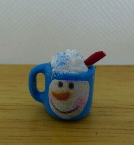 Miniature snowman mug with whipped cream and straw