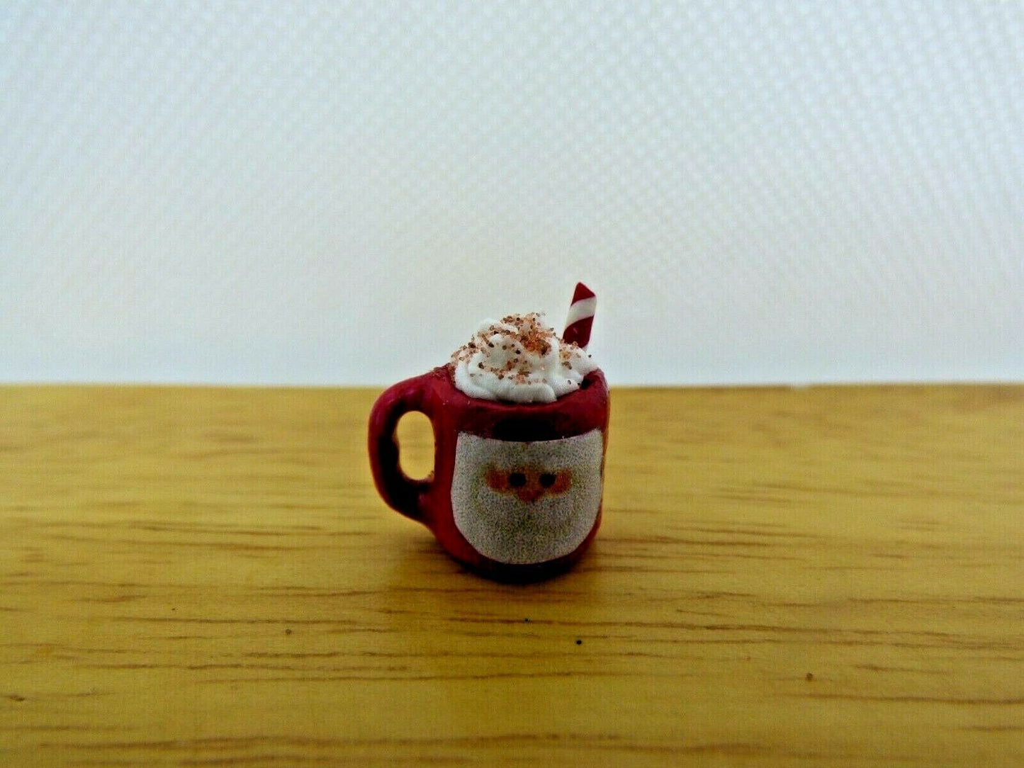 Miniature santa mug with whipped cream and straw